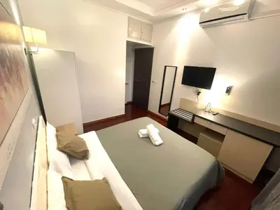 a room with a bed and a desk with a television at KayDee GuestHouse in Rome