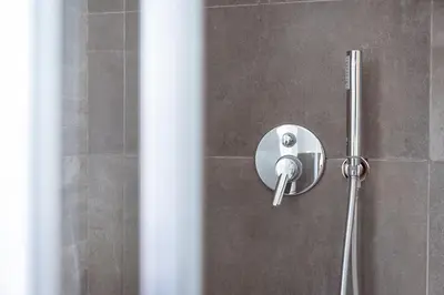 a shower with a shower head in a bathroom at Central Vatican Rooms in Rome
