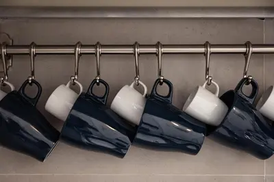 a group of hanging bags on a rack at Central Vatican Rooms in Rome