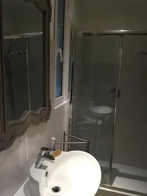 a bathroom with a white sink and a shower at Vatican City House Roma in Rome