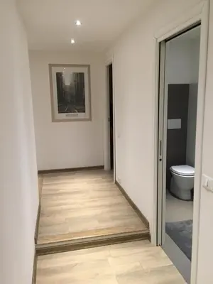 an empty hallway with a toilet and a doorway at Vatican City House Roma in Rome