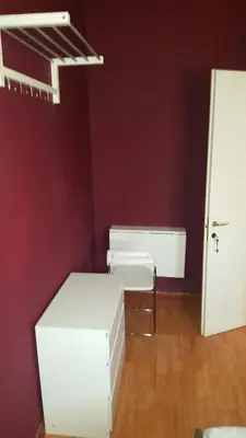 a room with white furniture and a red wall at Art in Accommodation in Rome