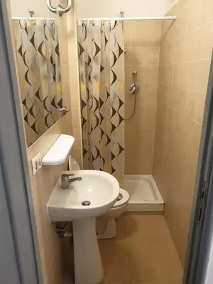 a bathroom with a sink and a toilet and a shower at Art in Accommodation in Rome