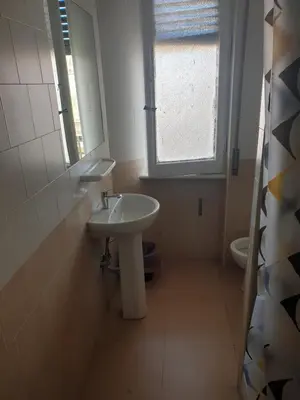 a bathroom with a sink and a window and a toilet at Art in Accommodation in Rome