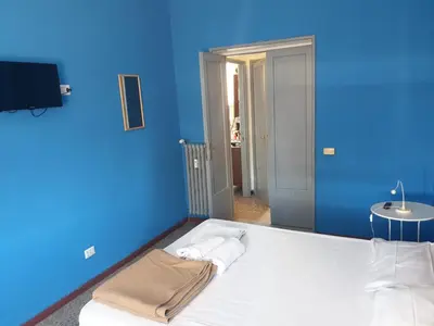 a blue room with a bed with a blue wall at Art in Accommodation in Rome