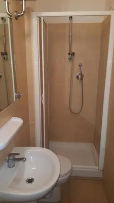 a bathroom with a shower and a toilet and a sink at Art in Accommodation in Rome