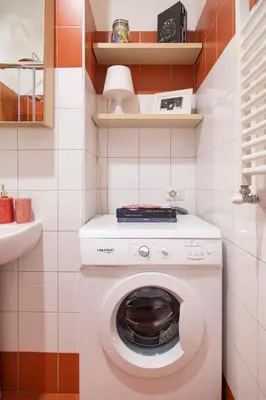 a washer and dryer in a small bathroom at TrastevereHome - Garibaldi Rome in Rome