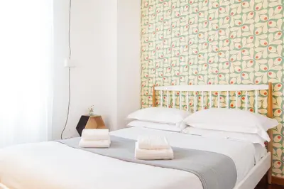 a bedroom with two beds with towels on them at TrastevereHome - Garibaldi Rome in Rome