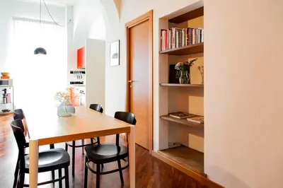 a kitchen and dining room with a table and chairs at TrastevereHome - Garibaldi Rome in Rome