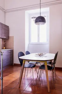 a dining room table and chairs in a kitchen at TrastevereHome - Peretti Rome in Rome