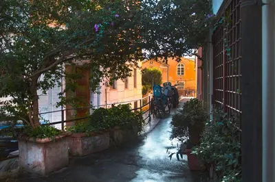 an alley with a horse drawn carriage on a street at TrastevereHome - Peretti Rome in Rome