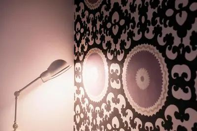 a lamp next to a wall with an animal print curtain at TrastevereHome - Secret Calisto Amazing View Trastevere Rooftops in Rome