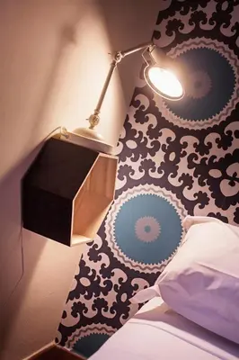 a bedroom with a lamp and a black and white wall at TrastevereHome - Secret Calisto Amazing View Trastevere Rooftops in Rome