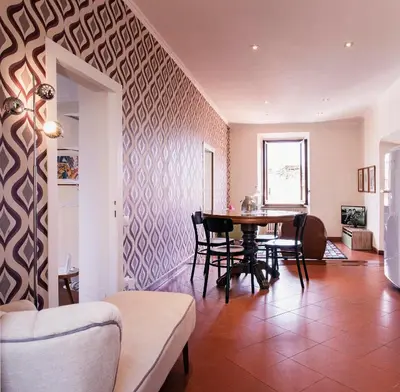 a living room with a table and chairs at TrastevereHome - Secret Calisto Amazing View Trastevere Rooftops in Rome