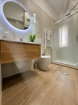 a bathroom with a sink and a toilet and a mirror at Buongiorno Colosseo in Rome