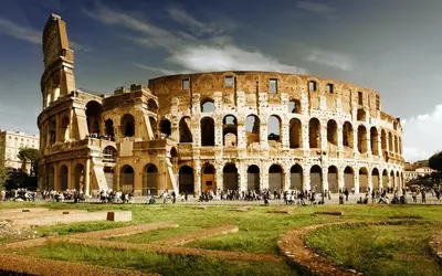 a group of people standing around the coliseum at Buongiorno Colosseo in Rome