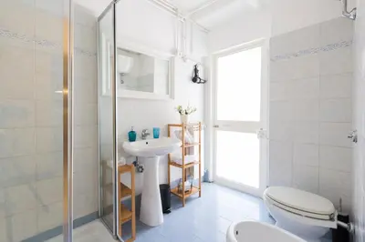a bathroom with a toilet and a sink and a shower at TrastevereHome - Ripa Rome Trastevere Home in Rome