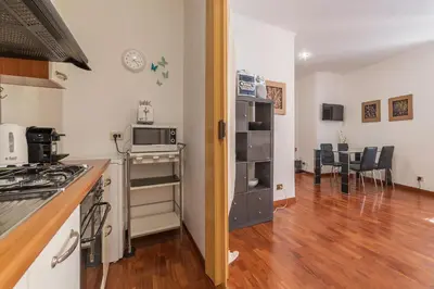 a kitchen with a stove and a counter top at Casa Zeffiro - FromHometoRome in Rome