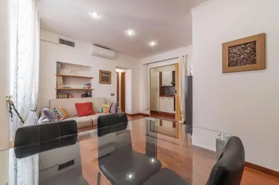 a living room with a couch and a glass table at Casa Zeffiro - FromHometoRome in Rome