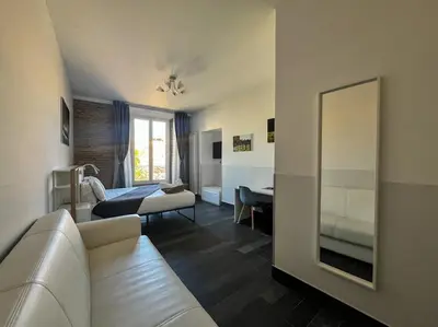 a bedroom with a large white bed and a couch at Arch Rome Suites in Rome