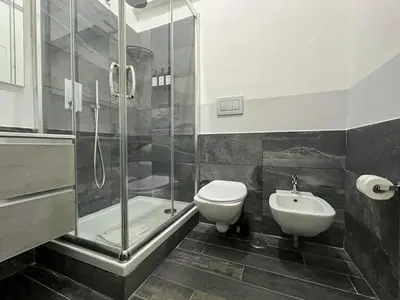 a bathroom with a sink and a shower and a tub at Arch Rome Suites in Rome