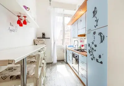 a kitchen with white cabinets and a refrigerator at Rome sweet home in Rome