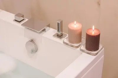 three candles sitting on top of a bath tub at Rhea Silvia Luxury Navona in Rome