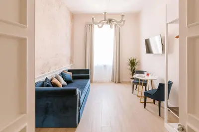 a living room with a black couch and a table at Rhea Silvia Luxury Navona in Rome
