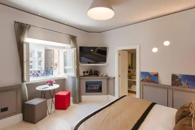 a bedroom with a bed and a fireplace and a tv at Rhea Silvia Luxury Navona in Rome
