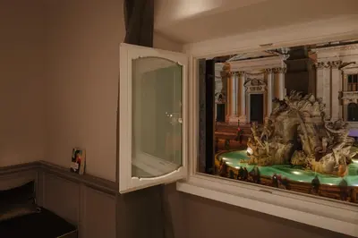 a window in a room with a statue in it at Rhea Silvia Luxury Navona in Rome