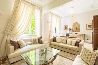 a living room with two couches and a glass table at Popologrande Apartment in Rome