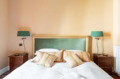 a bedroom with a bed with two lamps on night stands at Popologrande Apartment in Rome