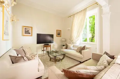 a living room with two couches and a tv at Popologrande Apartment in Rome
