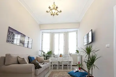 a living room with a couch and a table at Liberty Rome Apartment - Liberty Collection in Rome