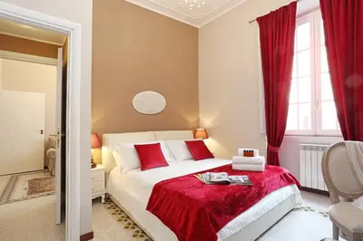 a bedroom with a bed with a red blanket at Liberty Rome Apartment - Liberty Collection in Rome