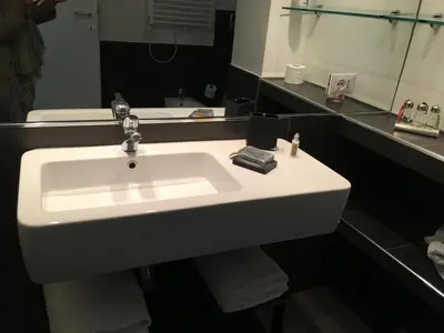 a white sink in a bathroom with a mirror at Megi San Peter Apartment in Rome