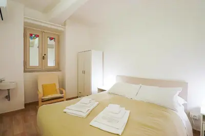 a bedroom with a bed with two towels on it at Labicana Apartment in Rome