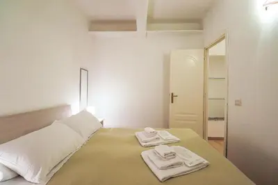 a bedroom with a bed with two towels on it at Labicana Apartment in Rome