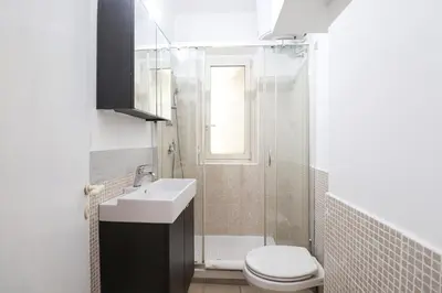 a bathroom with a toilet and a sink and a shower at Labicana Apartment in Rome