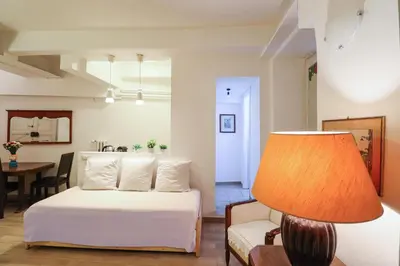 a bedroom with a bed and a chair and a table at Labicana Apartment in Rome