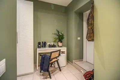 a room with a desk and a chair in it at Borgognona Rooms in Rome