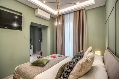a bedroom with a bed and a television in a room at Borgognona Rooms in Rome