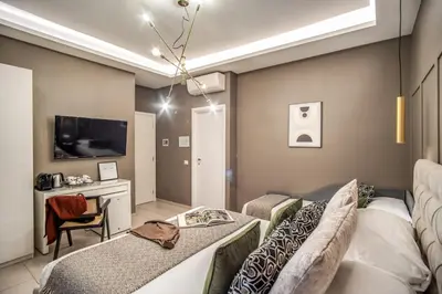 a living room with two couches and a tv at Borgognona Rooms in Rome
