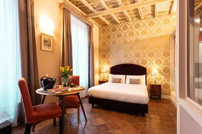 a hotel room with a bed and a table at Le Suite del Barone in Rome