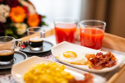 a table topped with plates of breakfast foods and drinks at Le Suite del Barone in Rome