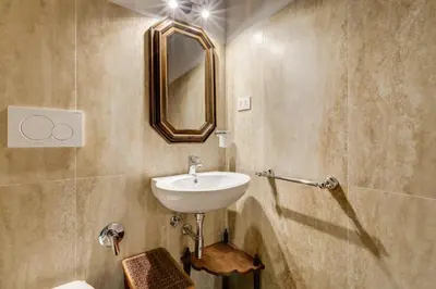 a bathroom with a sink and a mirror at Pellegrino Campo de' Fiori Suite in Rome