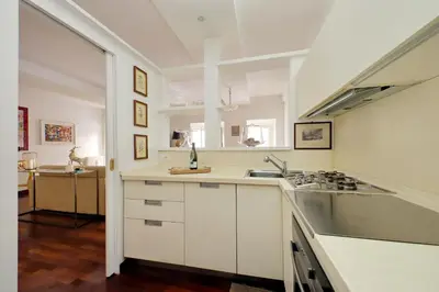 a white kitchen with a sink and a stove at The Pantheon view in the heart of Rome in Rome