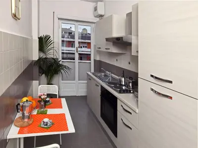 a small kitchen with a table and a sink at Alice Home in Rome
