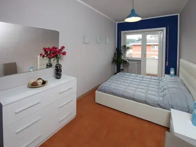 a bedroom with a bed and a dresser with flowers on it at Alice Home in Rome