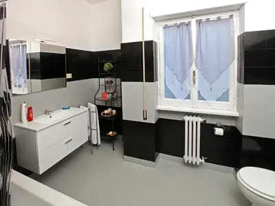 a bathroom with a sink and a toilet and a window at Alice Home in Rome
